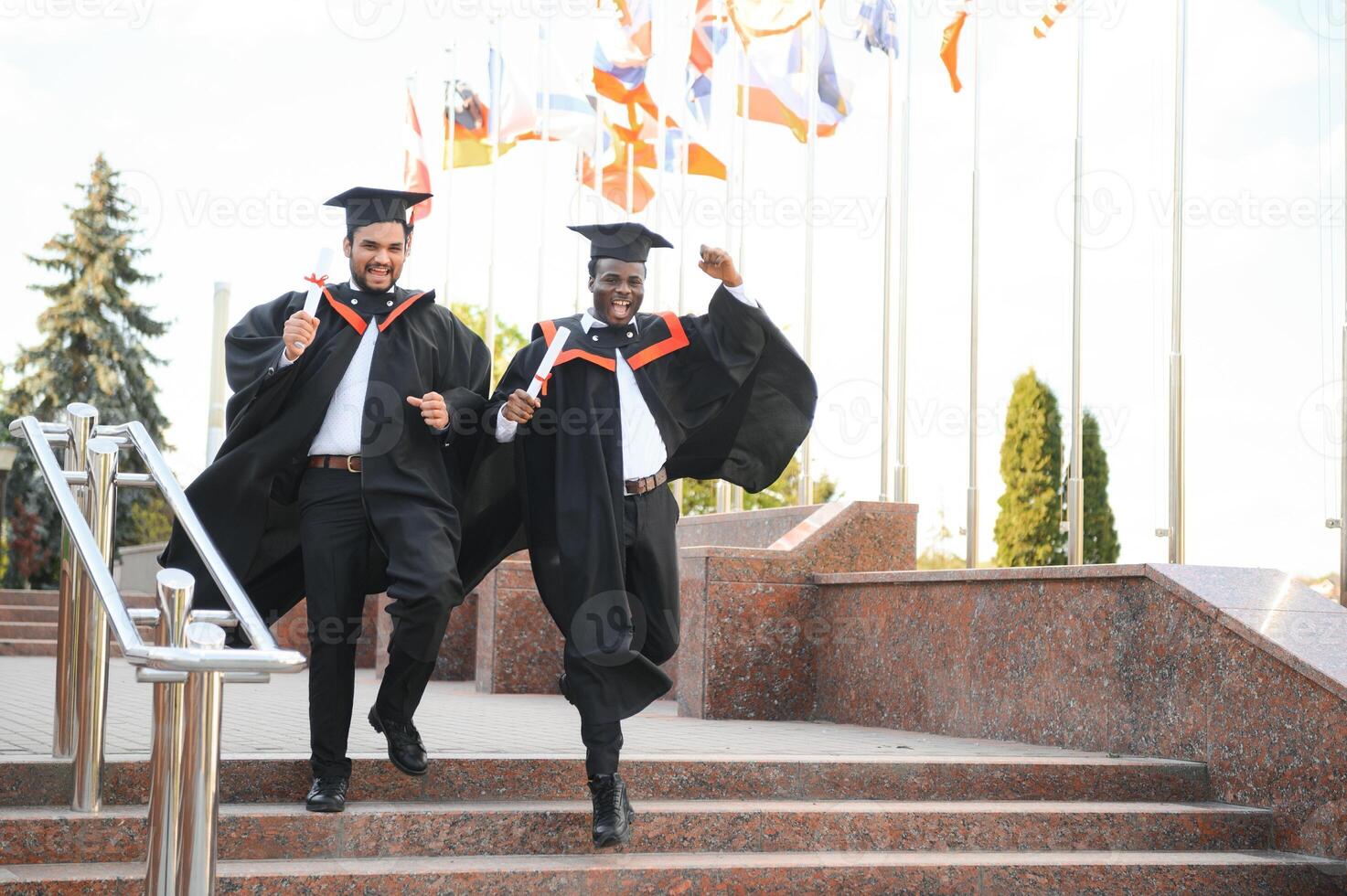 Happy boys students university graduates. Multiracial students photo