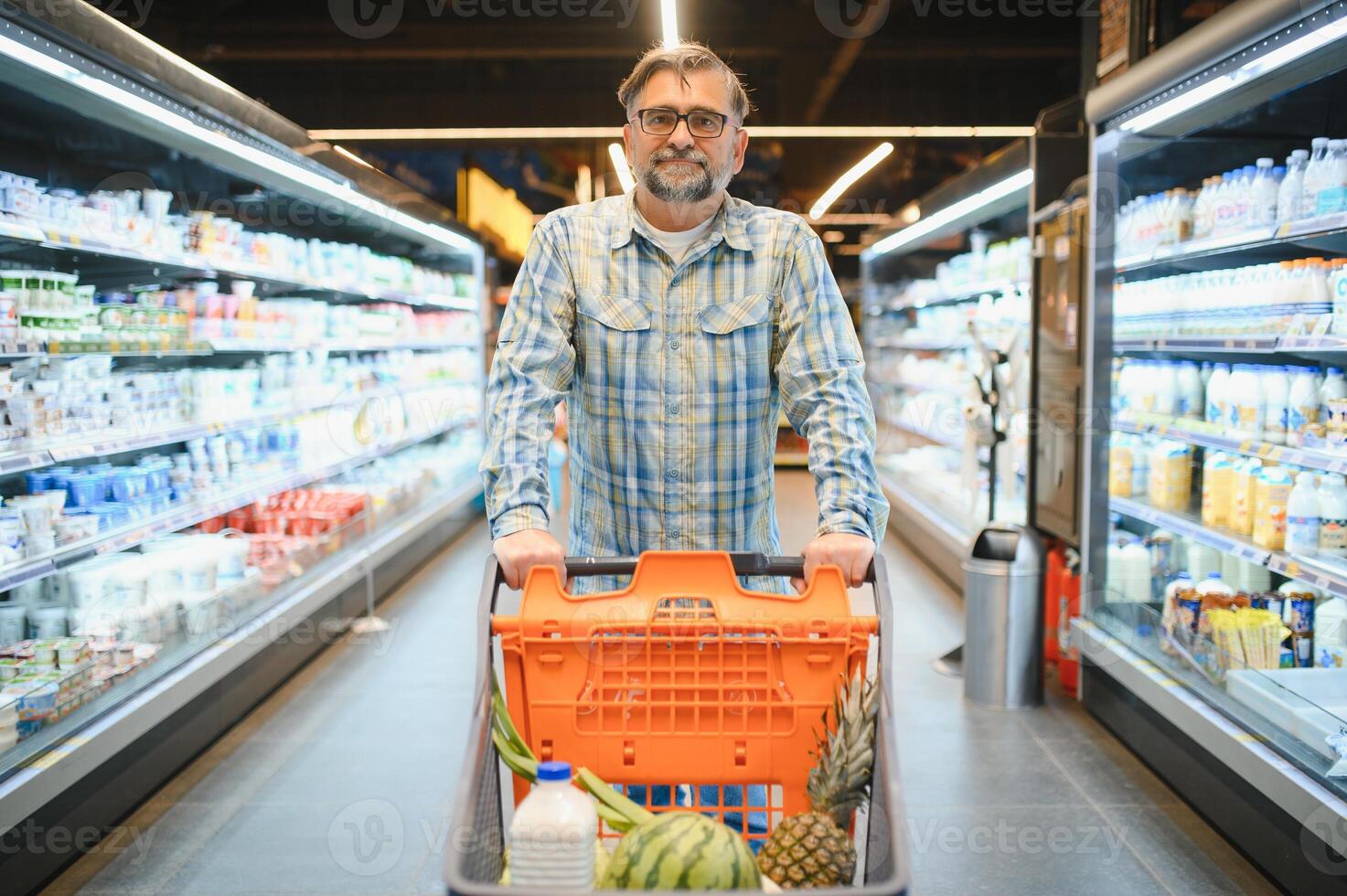 Handsome man shopping in a supermarket photo
