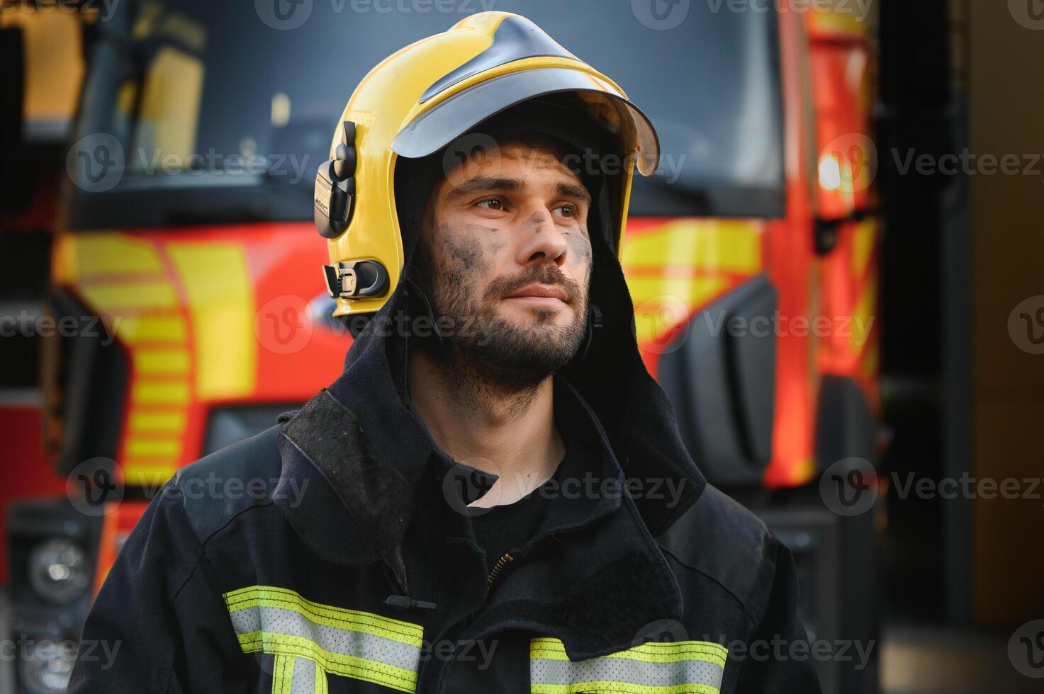 Photo of fireman with gas mask and helmet near fire engine