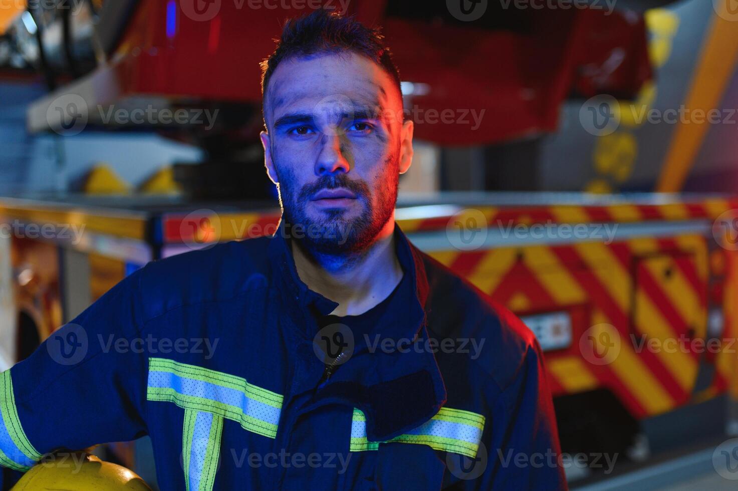 Photo of fireman with gas mask and helmet near fire engine