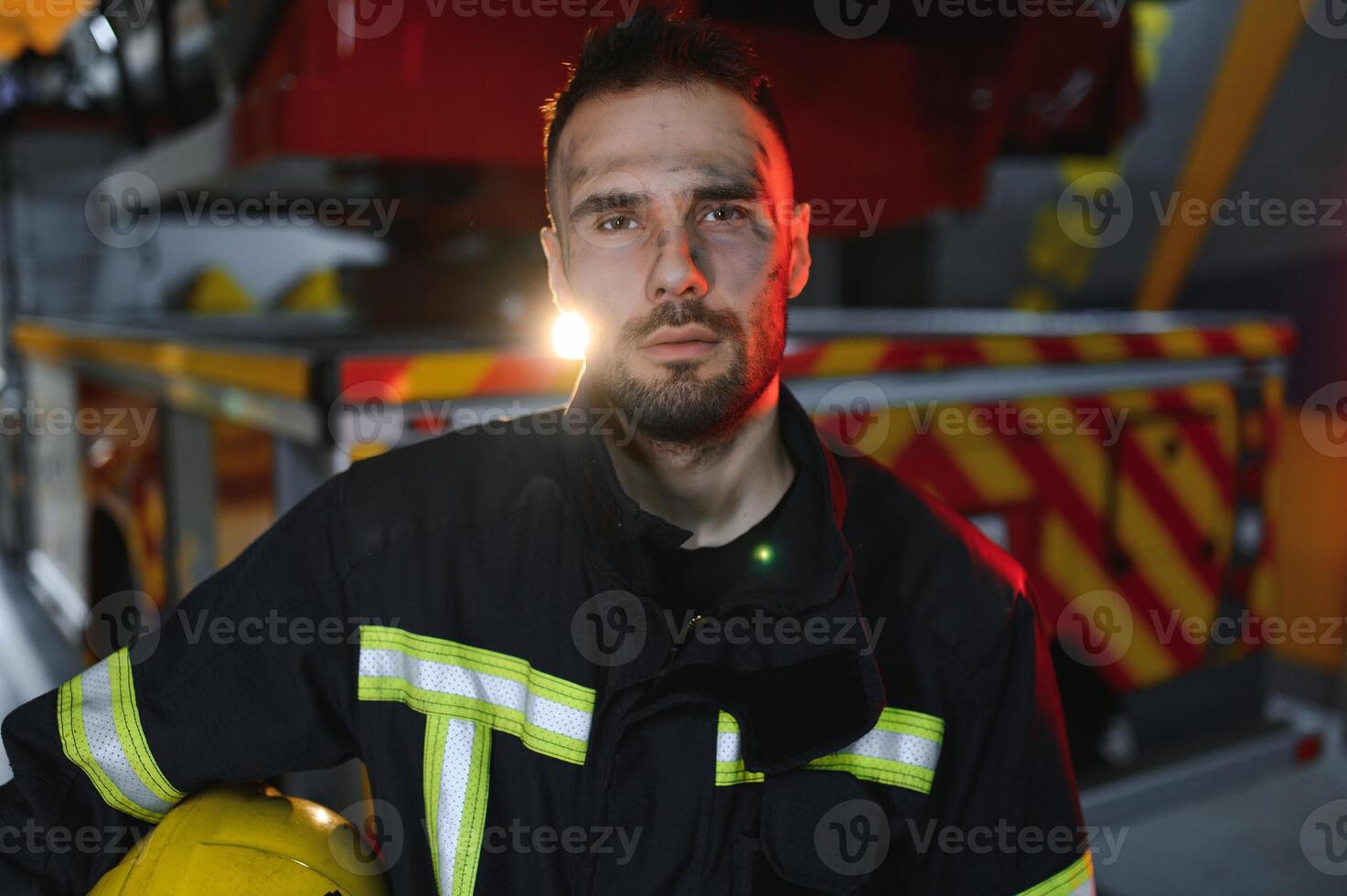 Firefighter rests after fighting a house fire photo