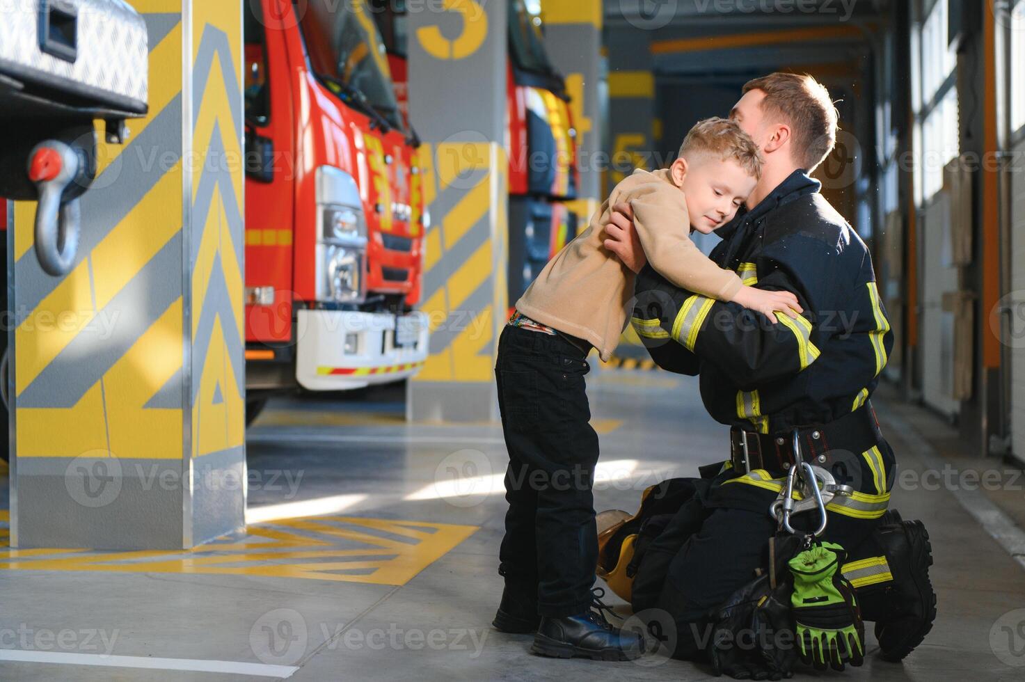 Firefighter holding child boy to save him in fire and smoke,Firemen rescue the boys from fire photo