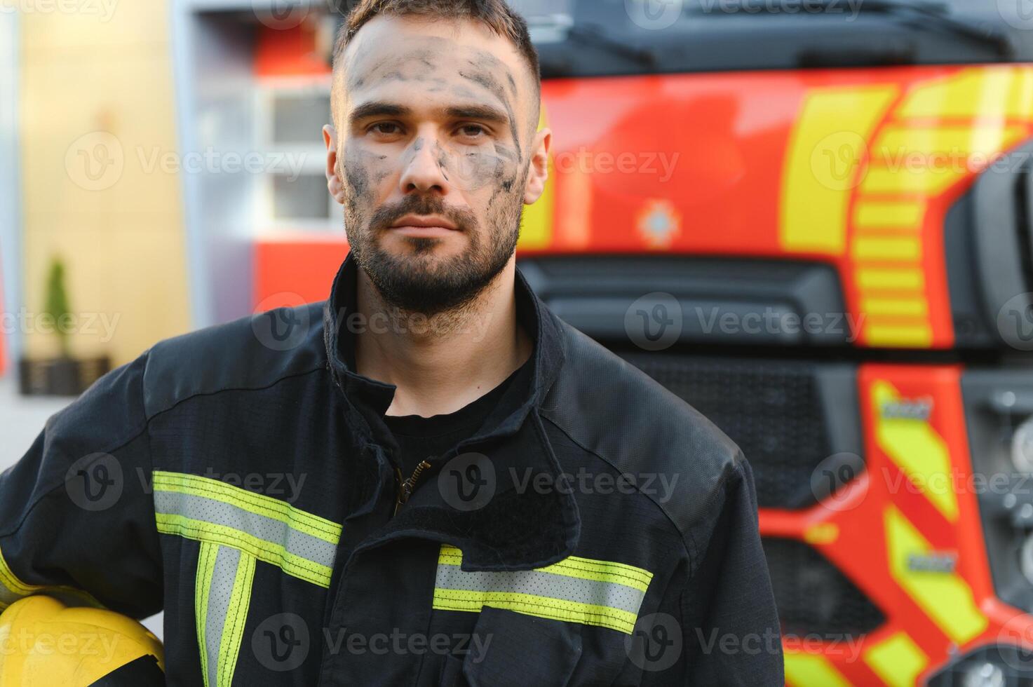 Photo of fireman with gas mask and helmet near fire engine