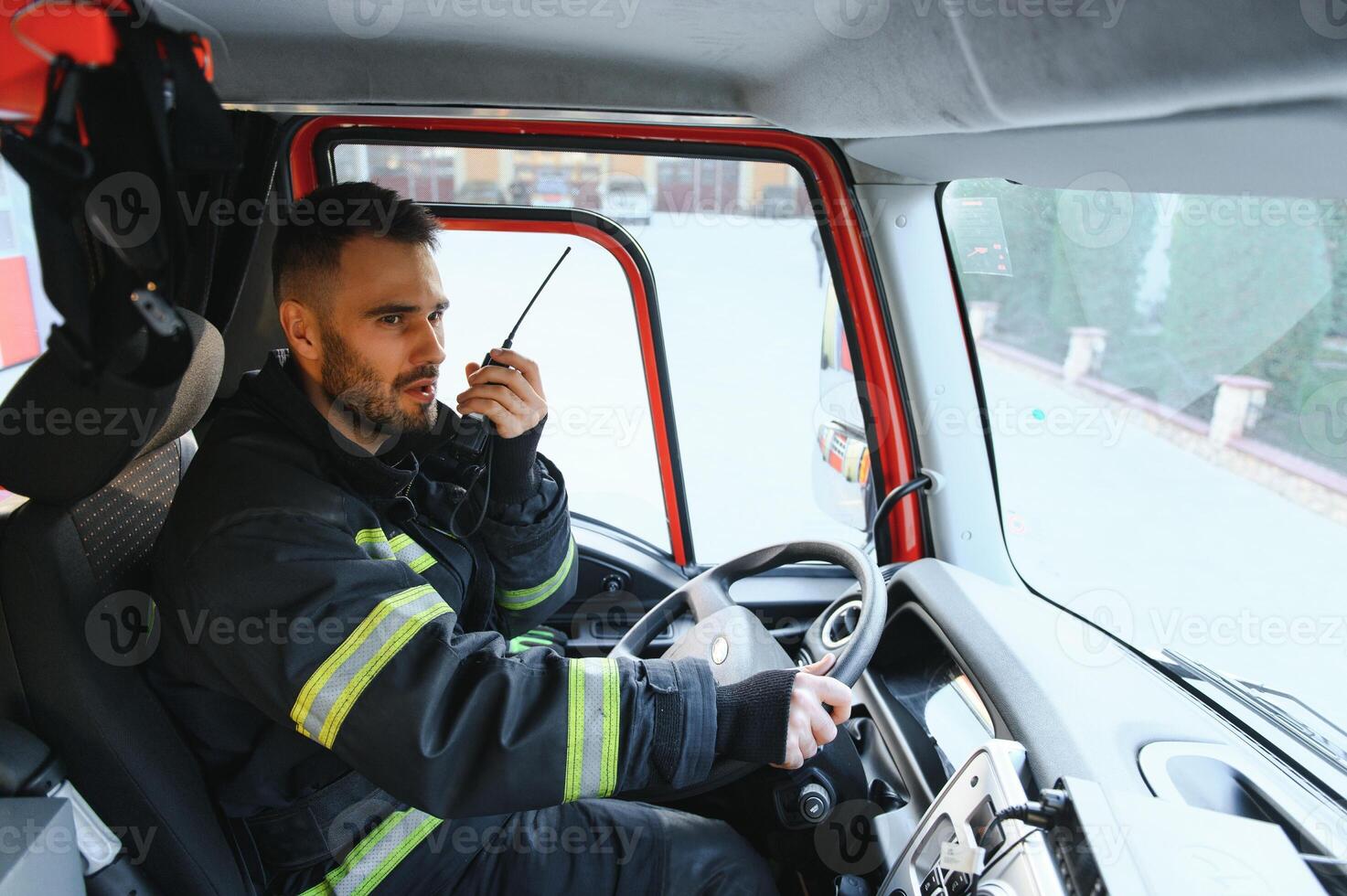 Firefighter drives a emergency vehicle with communication interior view photo