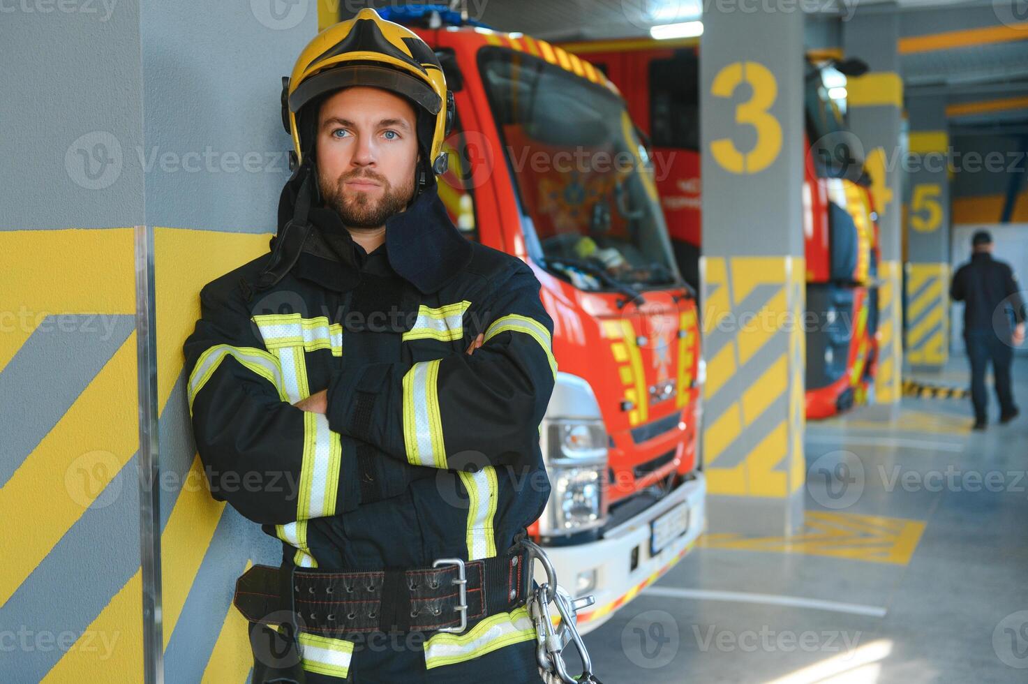 Portrait of male firefighter in uniform at fire station photo