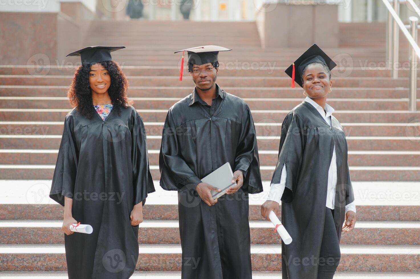optimistic young university graduates at graduation photo