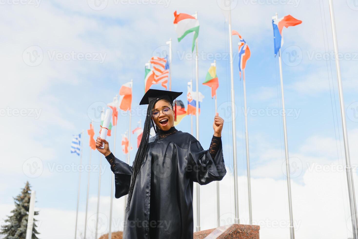 happy african american female student with diploma at graduation photo