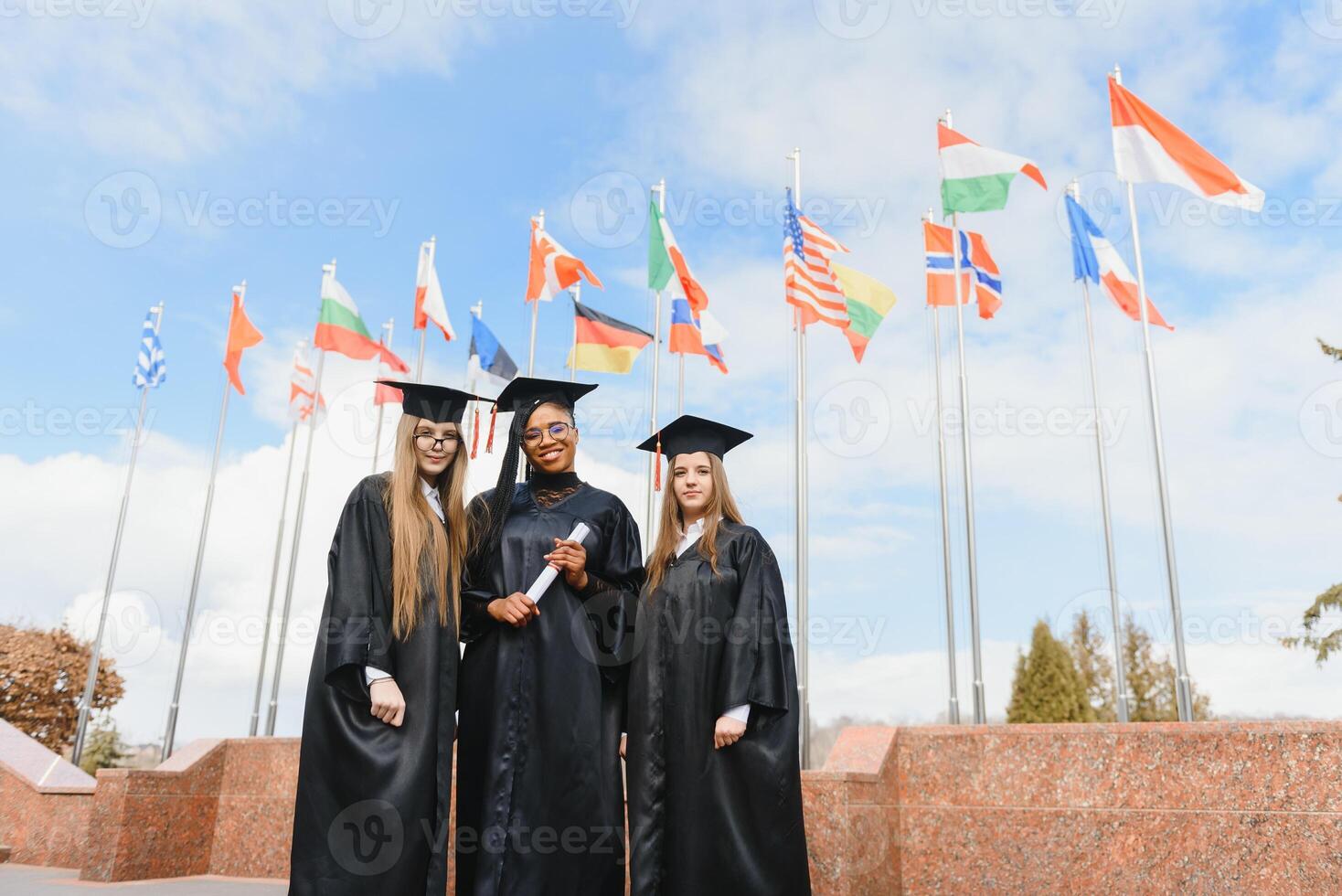 group of multiracial university graduates at graduation ceremony photo