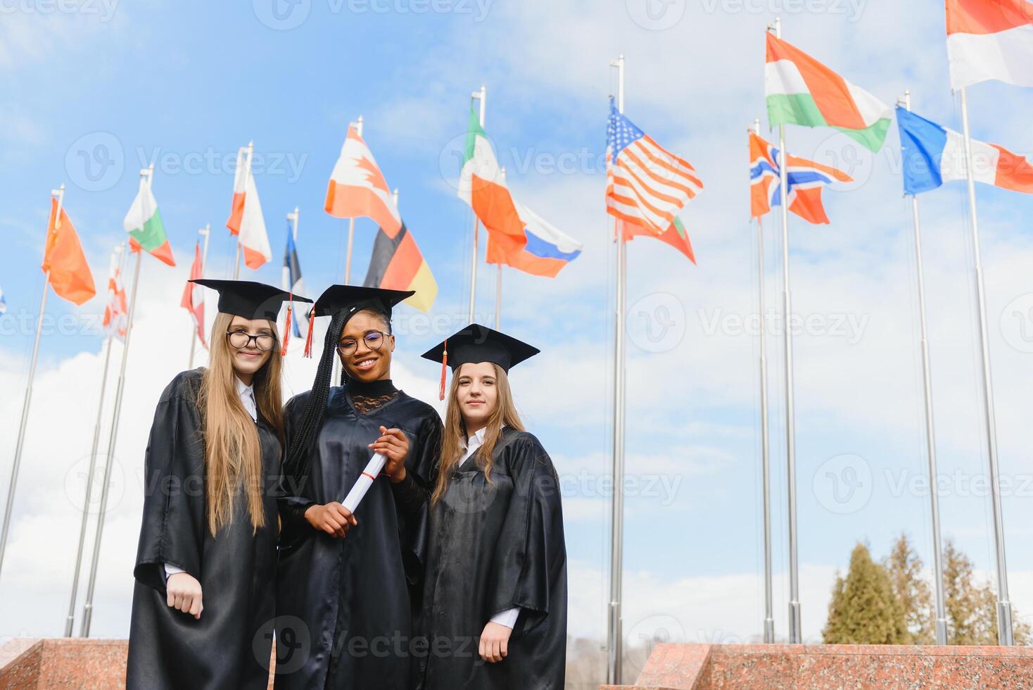group of multiracial university graduates at graduation ceremony photo
