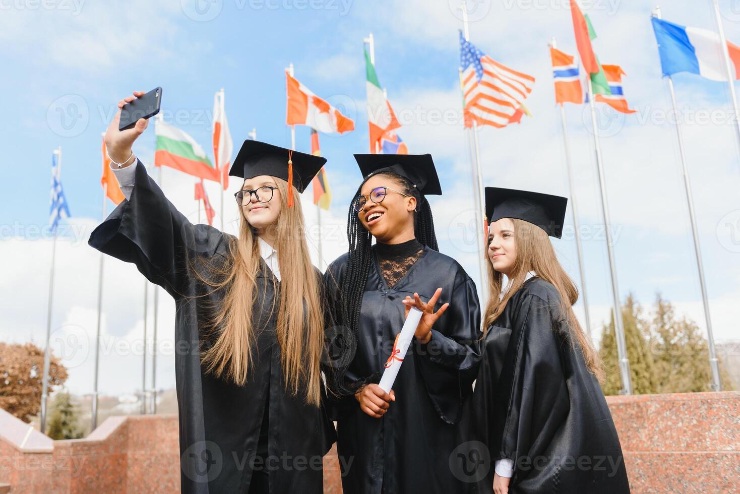 group of multiracial university graduates at graduation ceremony photo