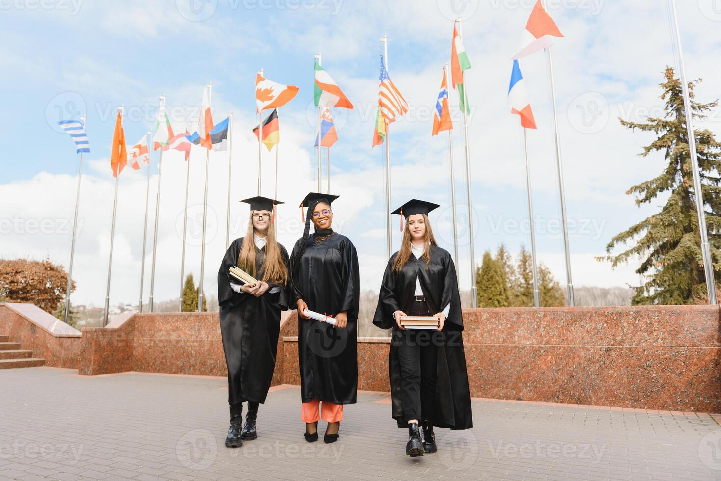 group of multiracial university graduates at graduation ceremony photo