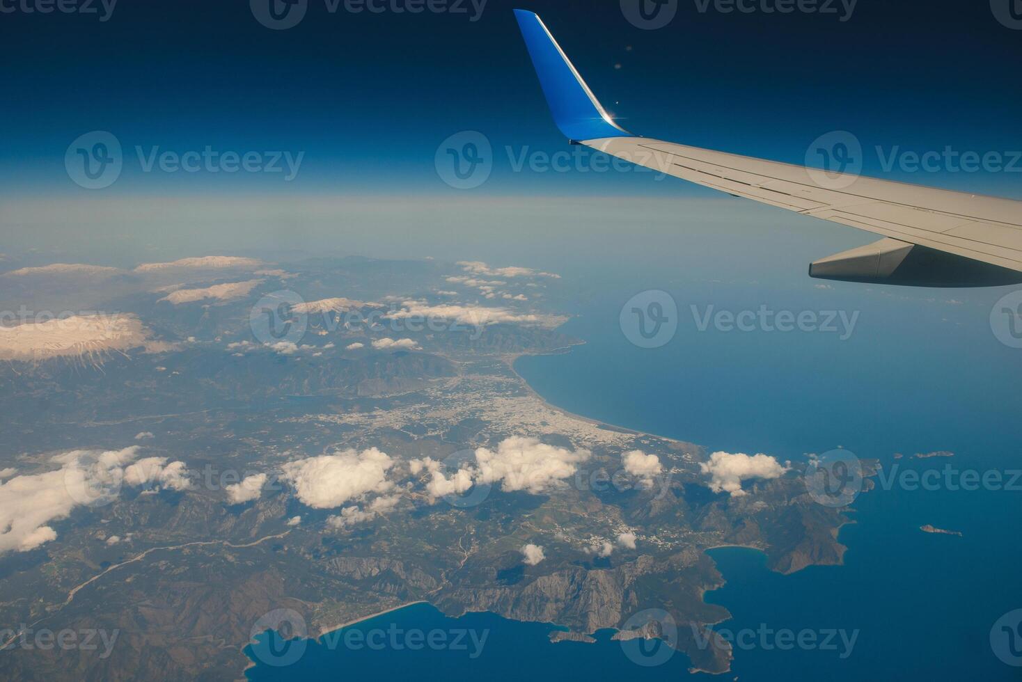 Looking through window aircraft during flight in wing with a nice blue sky photo