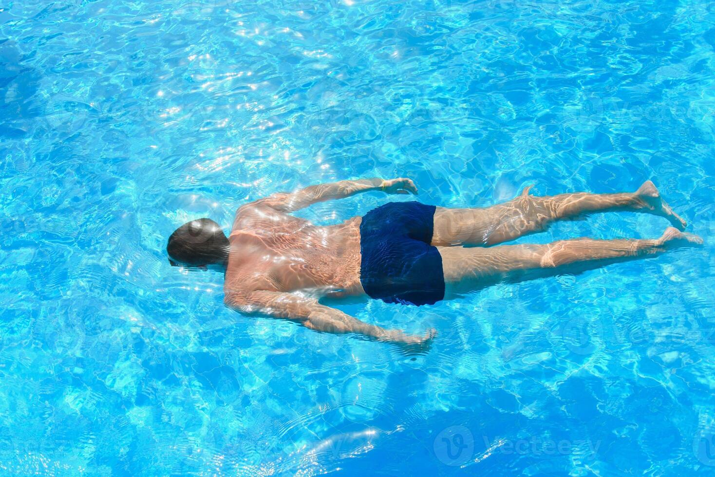 professional swimmer underwater after the jump photo