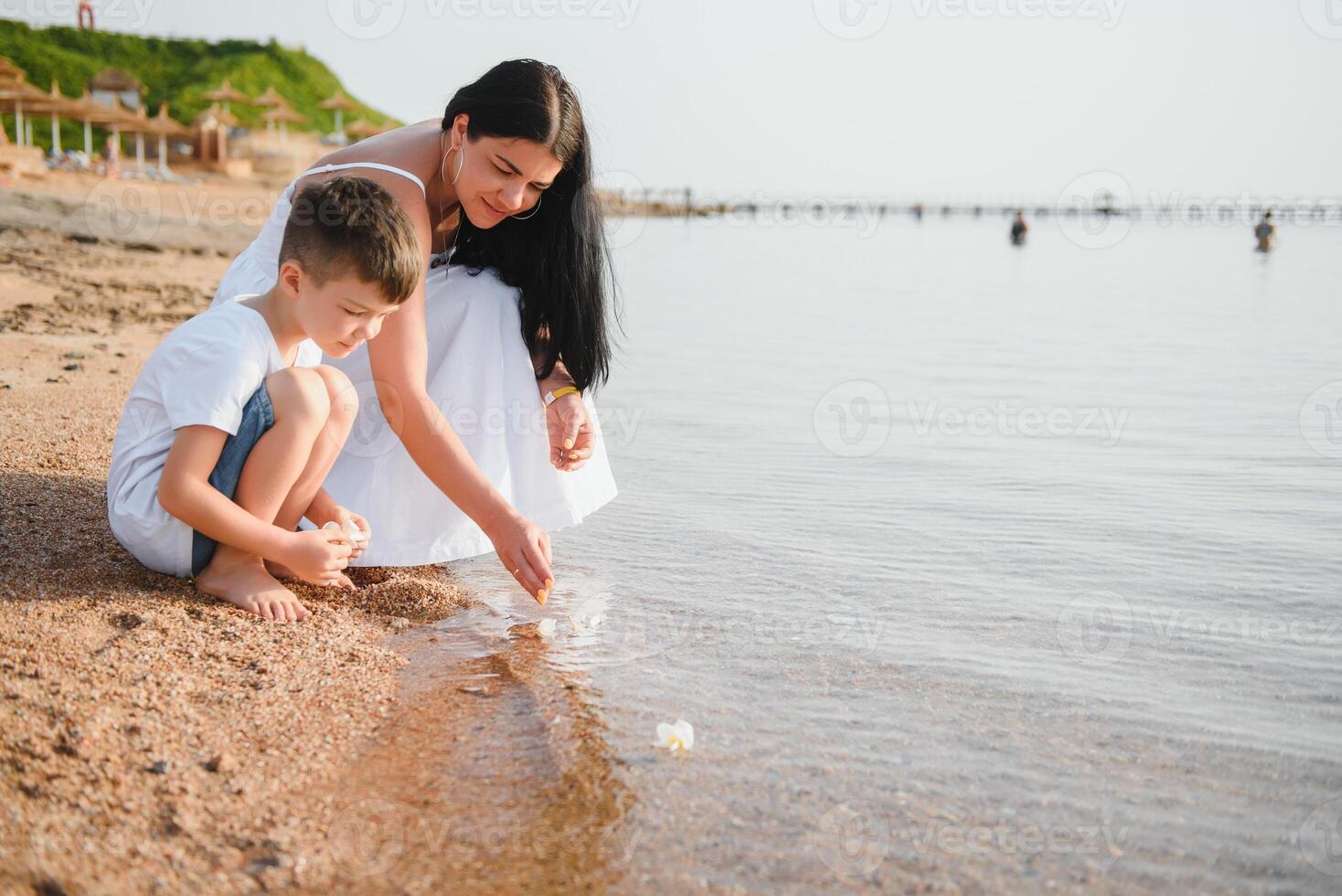 happy mother with son walk on beach, family at sea photo