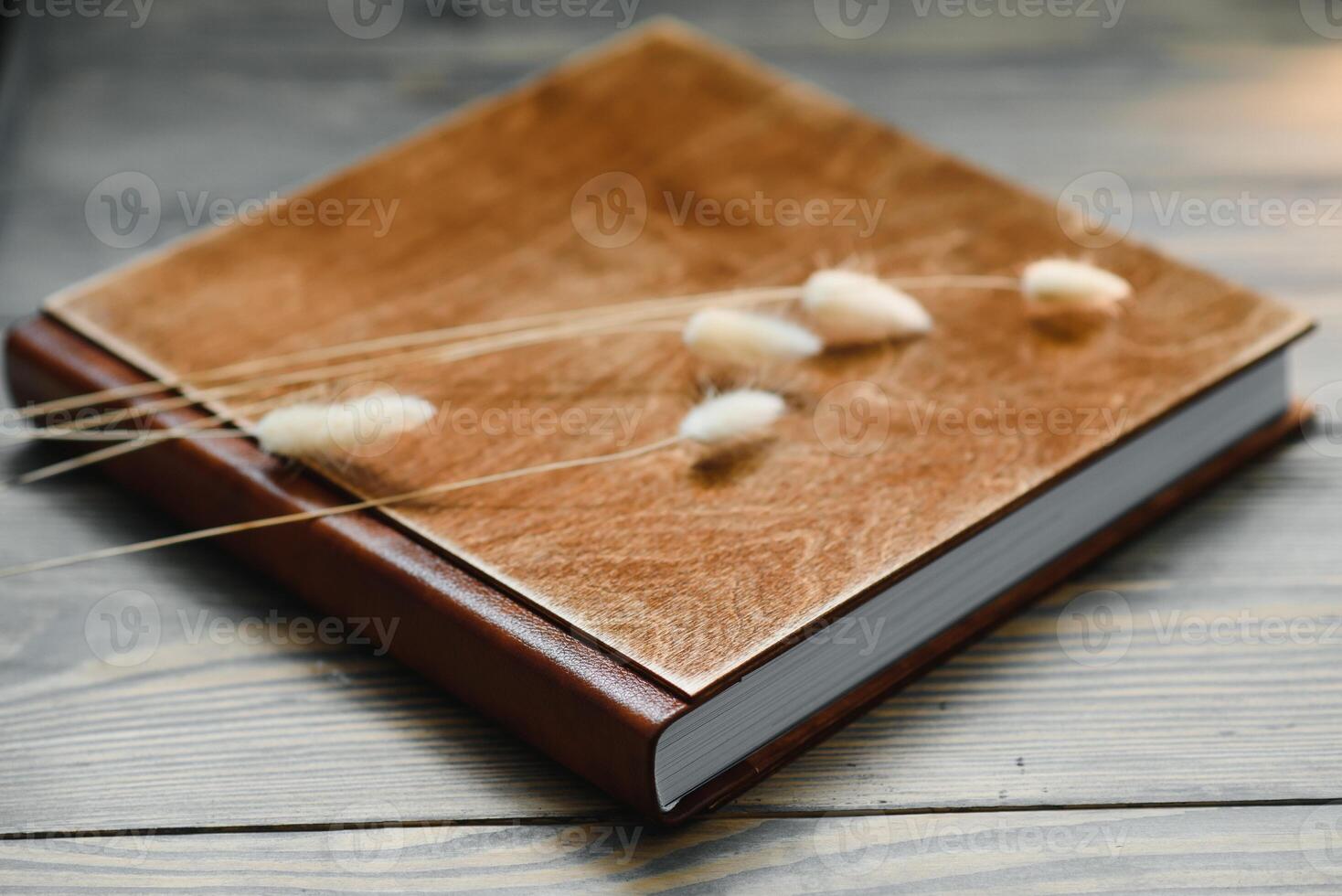 Luxury wooden photo book on natural background. Family memories photobook. Save your summer vacation memories. Photo album wedding photoalbum with wooden cover.