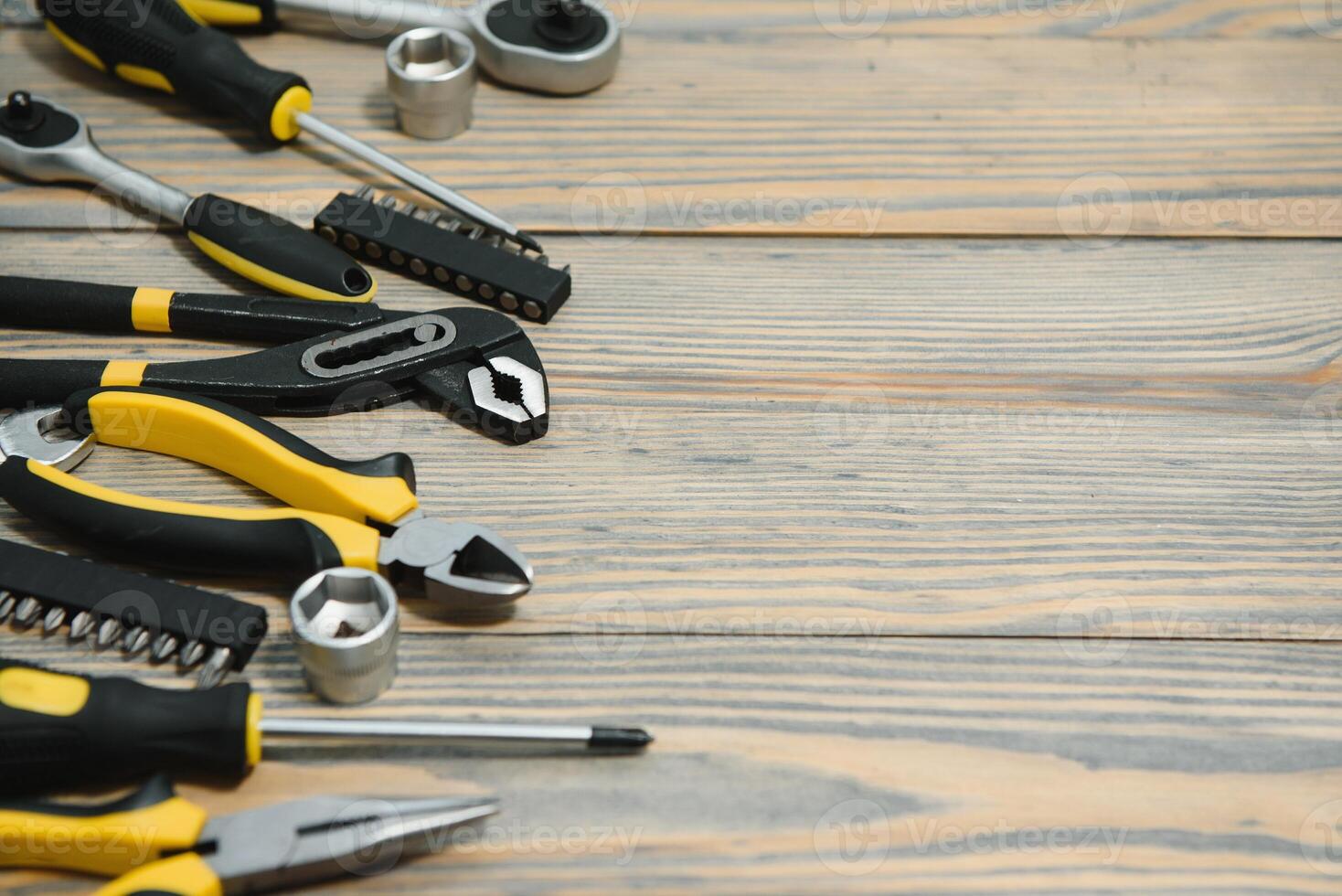 Different construction tools on a wooden background with copy space photo