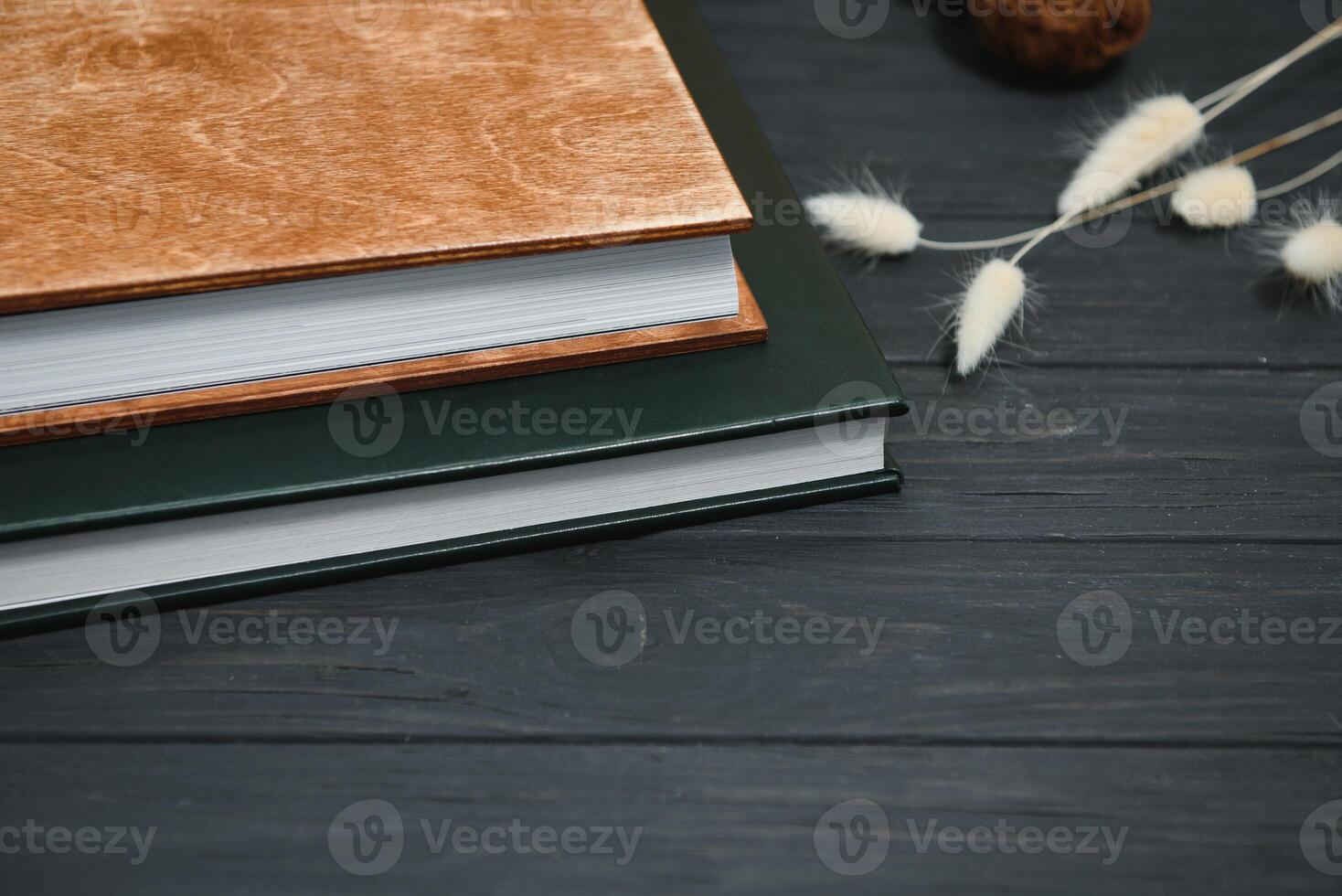 Green wedding or family photo book with leather cover. stylish wedding photo album close up. family photoalbum on wooden background.