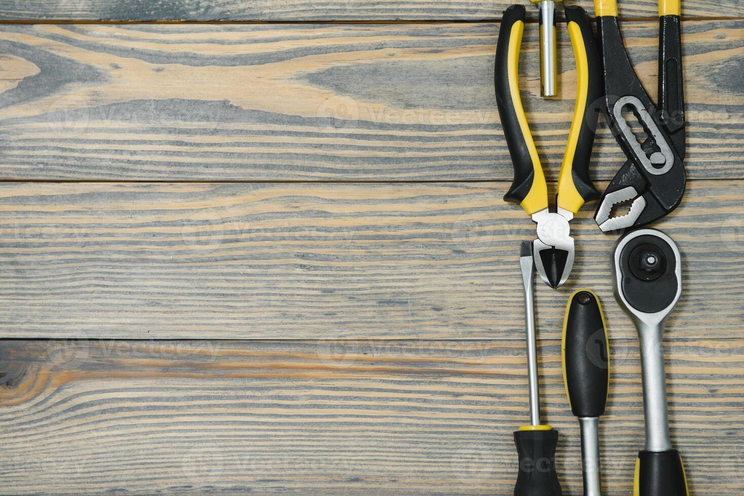 Various tools on wooden background photo