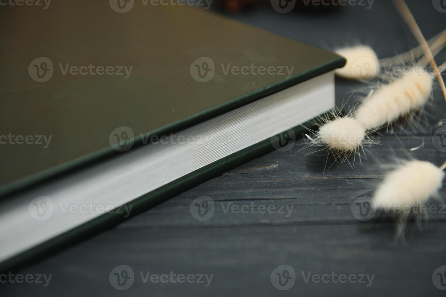 Green wedding or family photo book with leather cover. stylish wedding photo album close up. family photoalbum on wooden background.