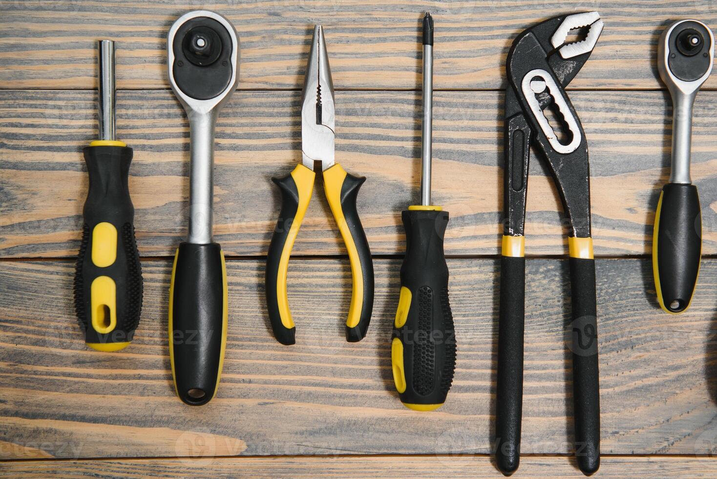 Set of tools over a wood panel with space for text photo