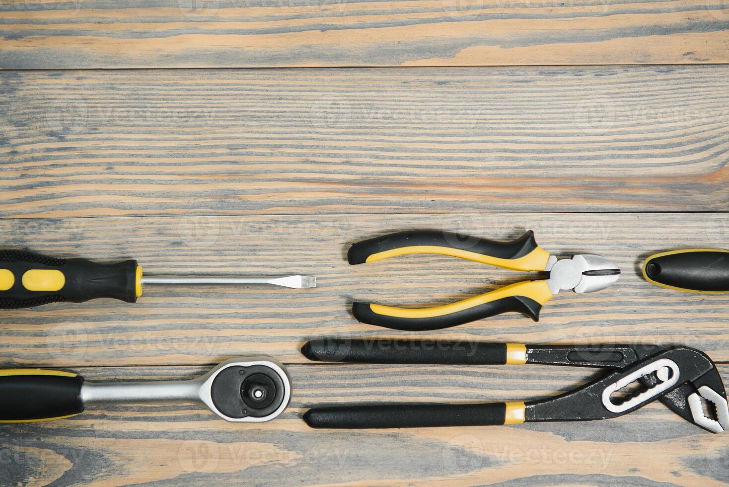 Set of tools over a wood panel with space for text photo