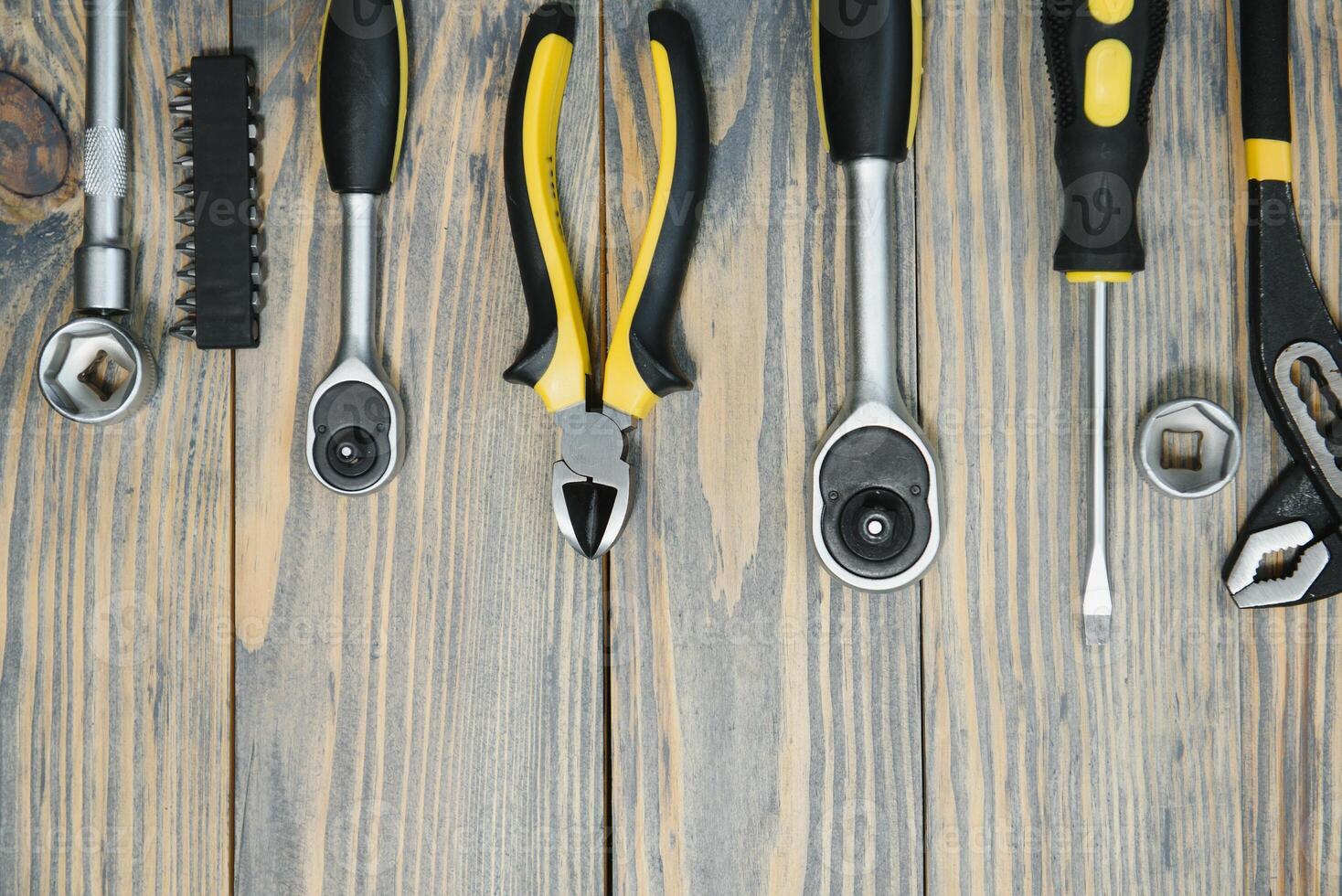 Set of tools over a wood panel with space for text photo