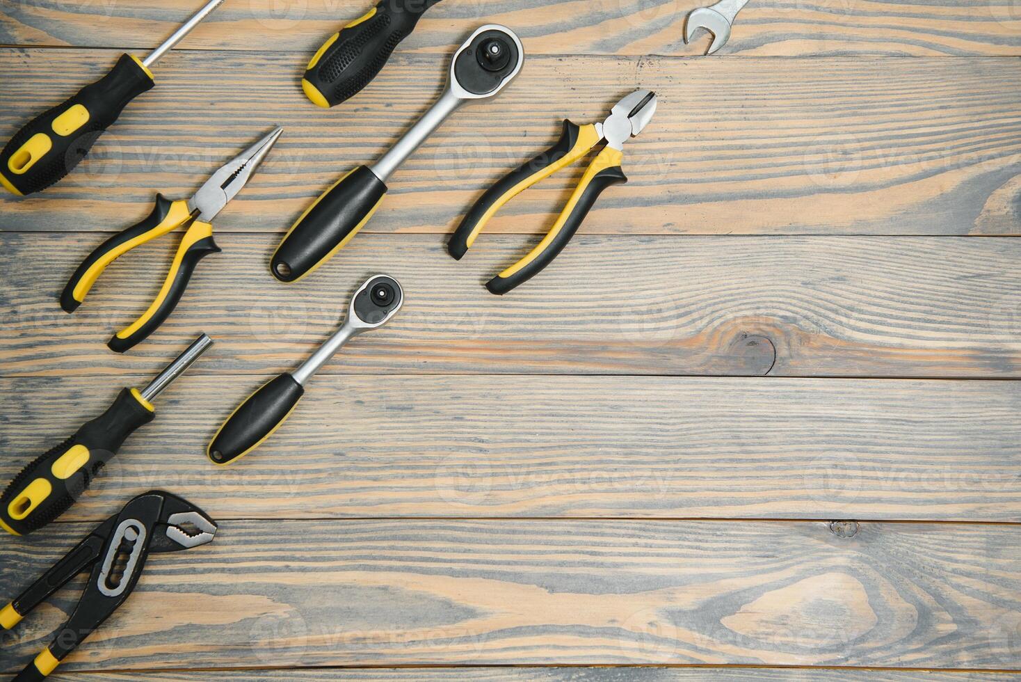 Set of tools over a wood panel with space for text photo