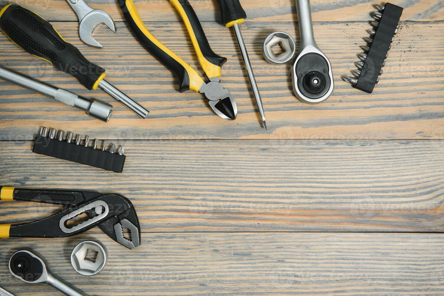 Different construction tools on a wooden background with copy space photo