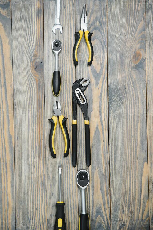 Various tools on wooden background photo