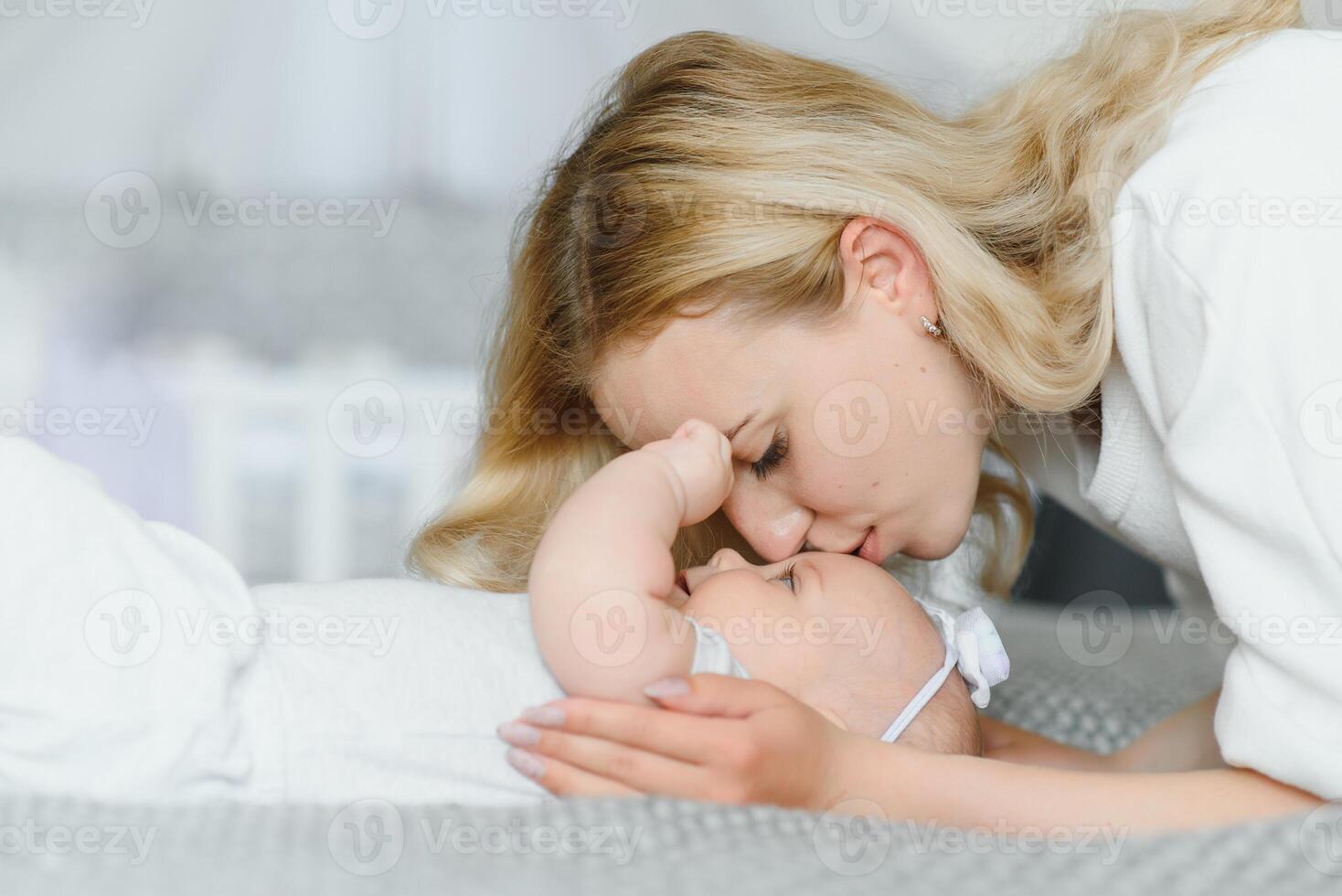 Portrait of mother and child laughing and playing photo