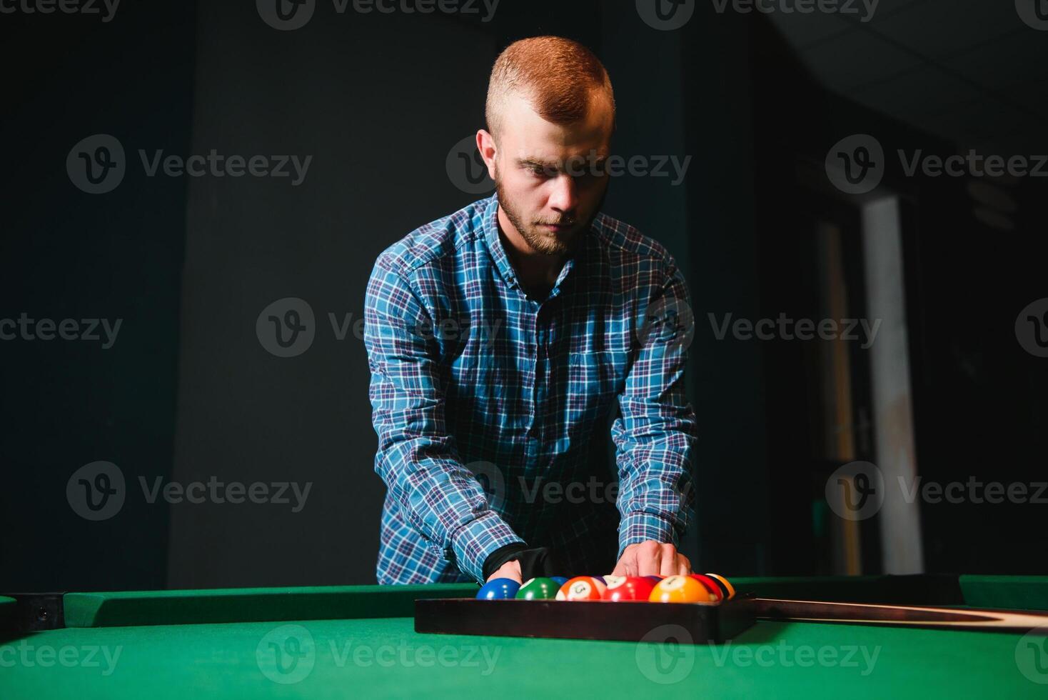 Playing billiard - Close-up shot of a man playing billiard photo