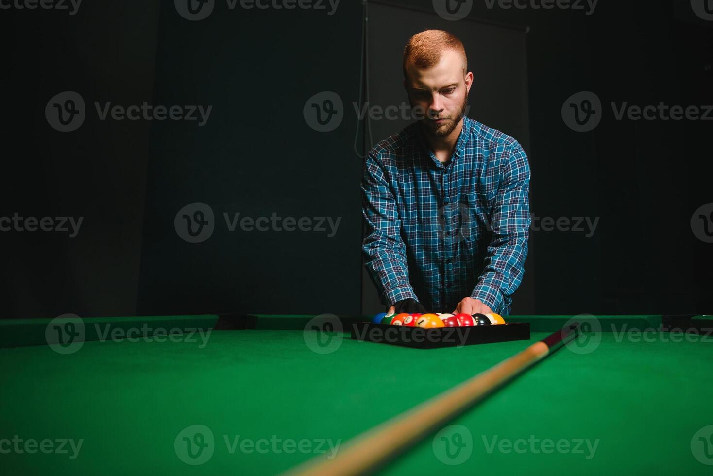 Playing billiard - Close-up shot of a man playing billiard photo