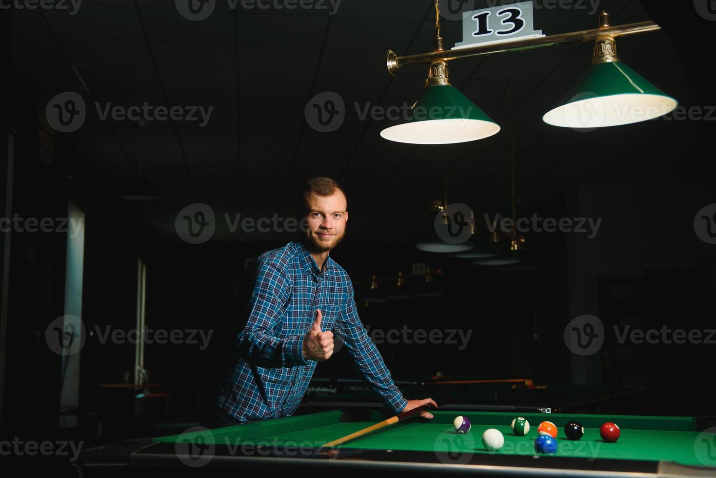 Playing billiard - Close-up shot of a man playing billiard photo
