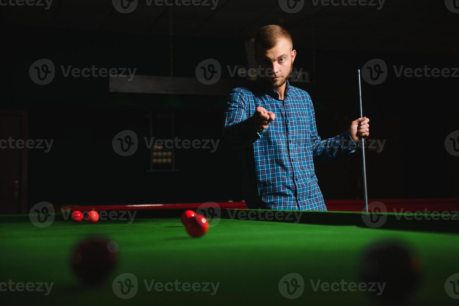 Playing billiard - Close-up shot of a man playing billiard photo