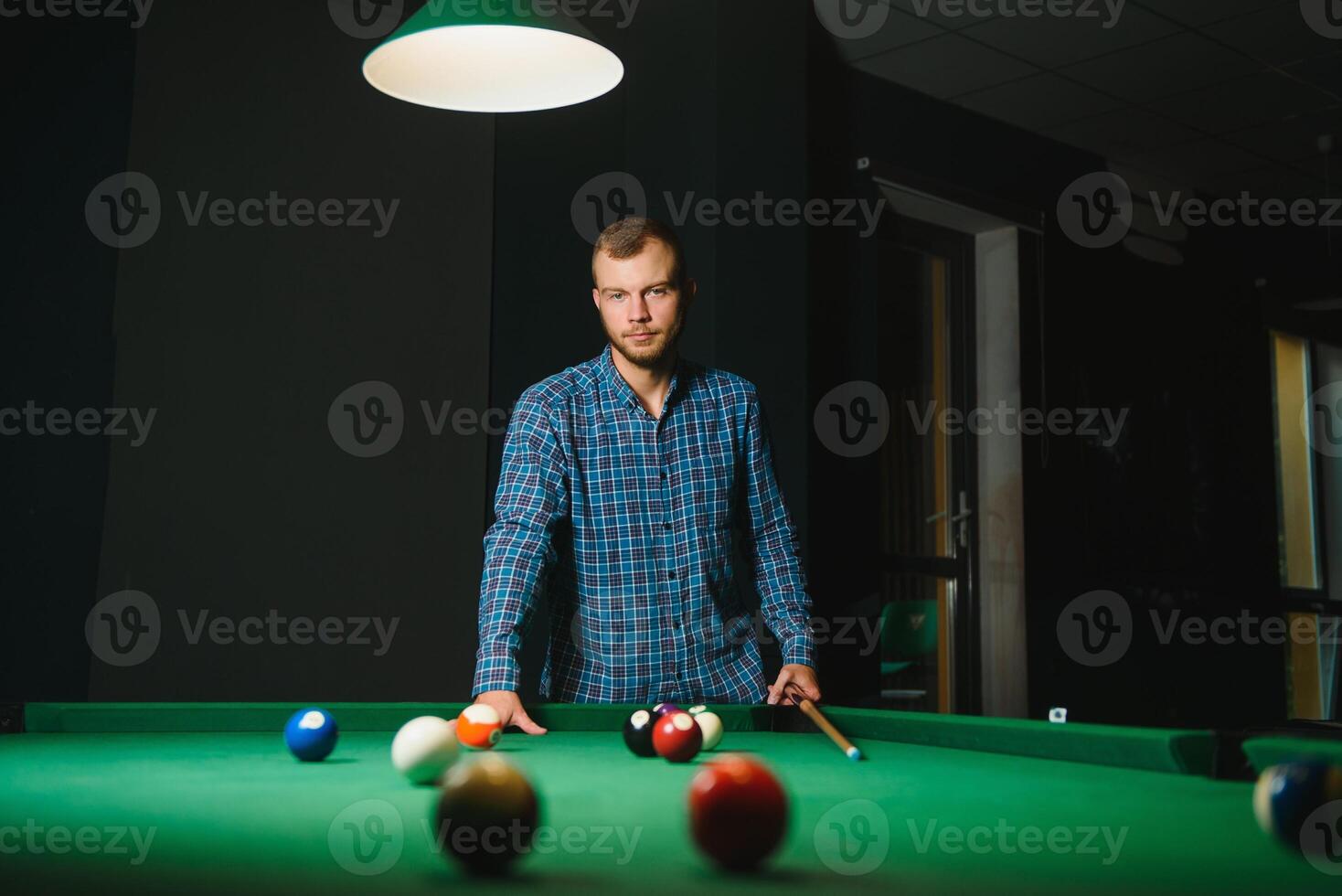 Playing billiard - Close-up shot of a man playing billiard photo