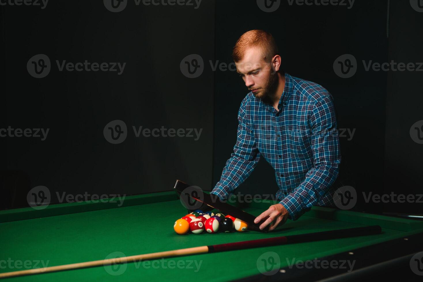 Man playing billiards in a club photo