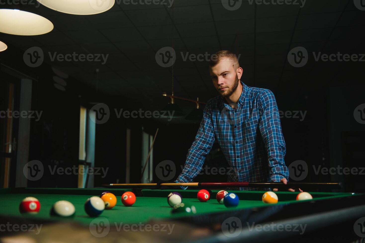 Playing billiard - Close-up shot of a man playing billiard photo