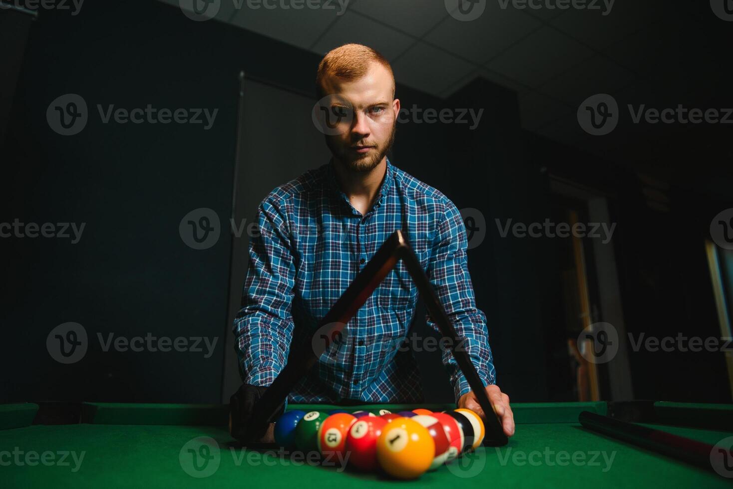 Playing billiard - Close-up shot of a man playing billiard photo
