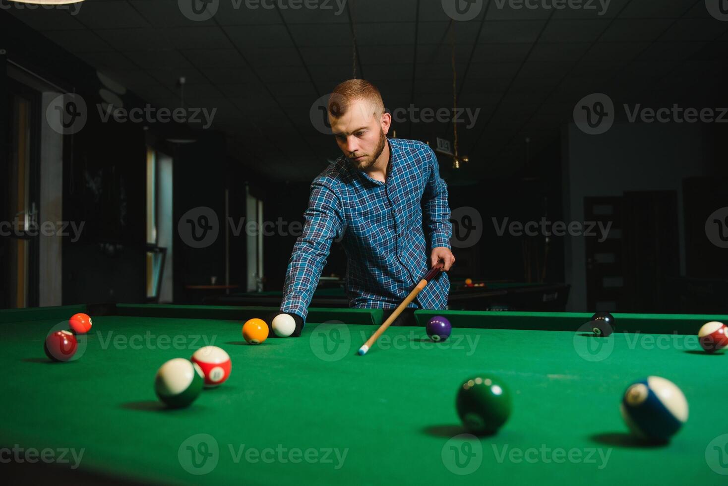 Playing billiard - Close-up shot of a man playing billiard photo
