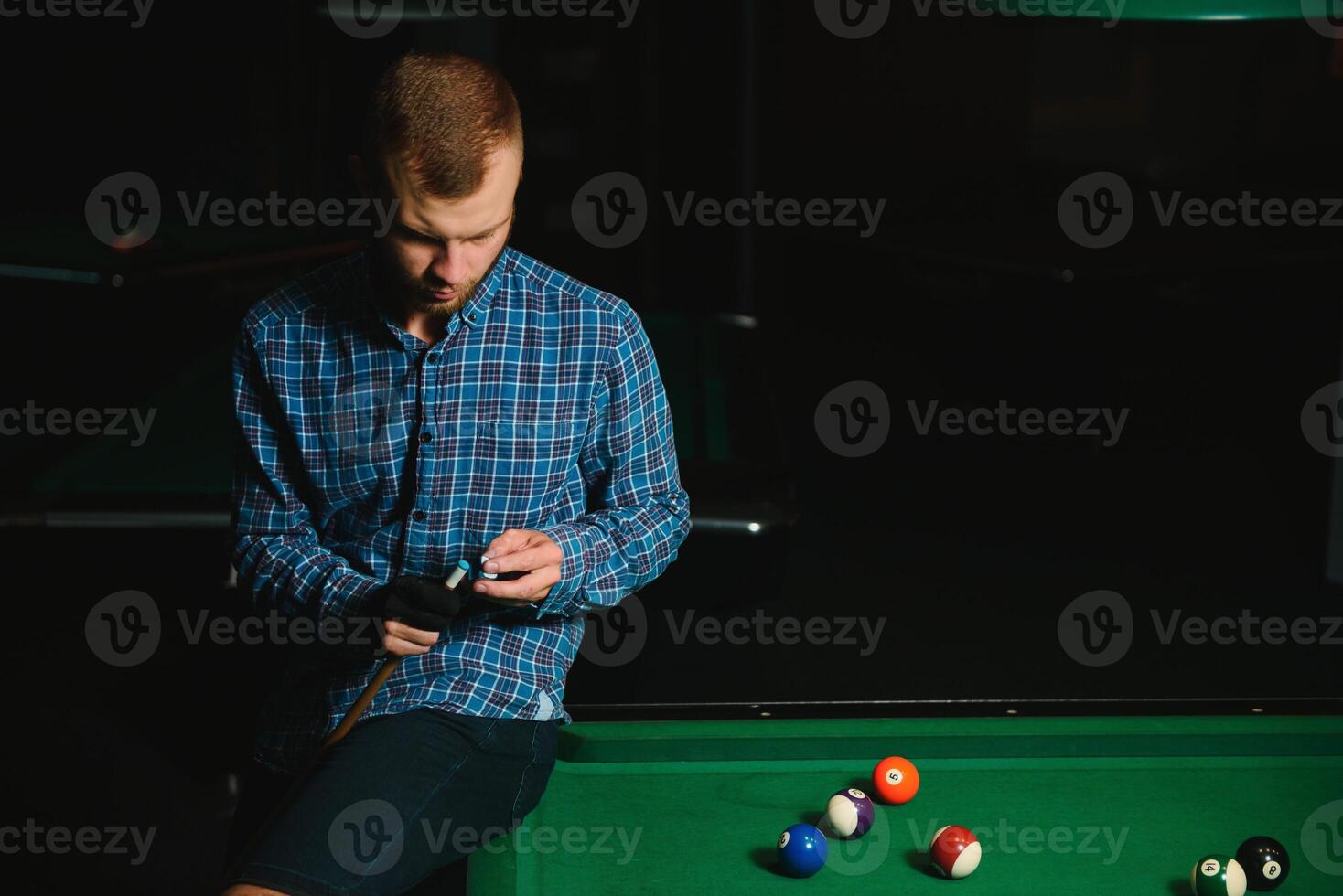 Man playing billiards in a club photo