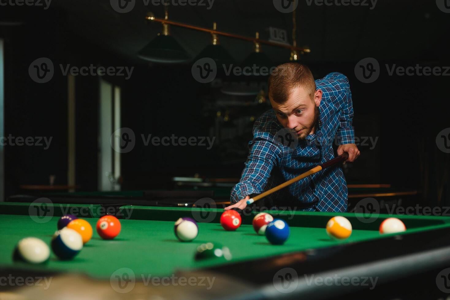 Man playing billiards in a club photo