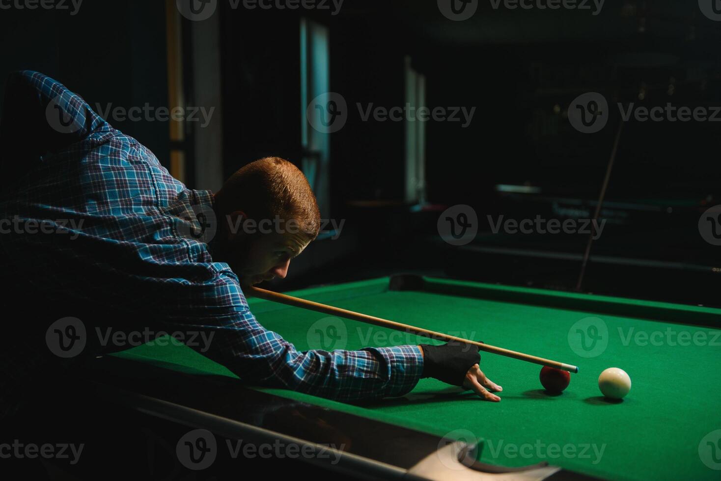 Playing billiard - Close-up shot of a man playing billiard photo
