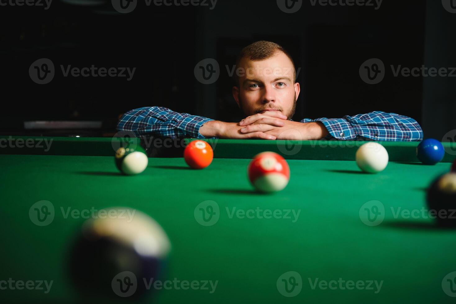 Playing billiard - Close-up shot of a man playing billiard photo