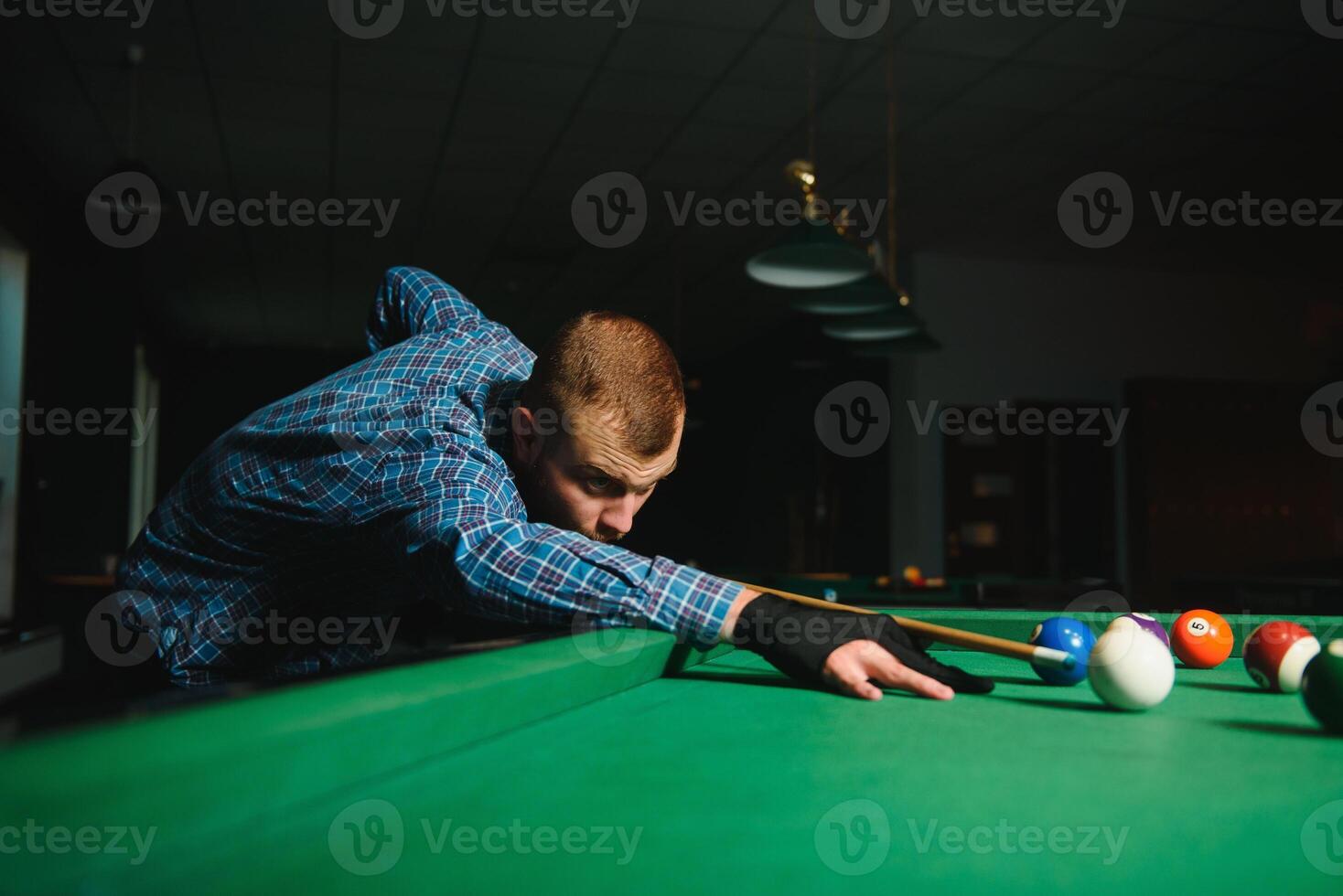 Man playing billiards in a club photo