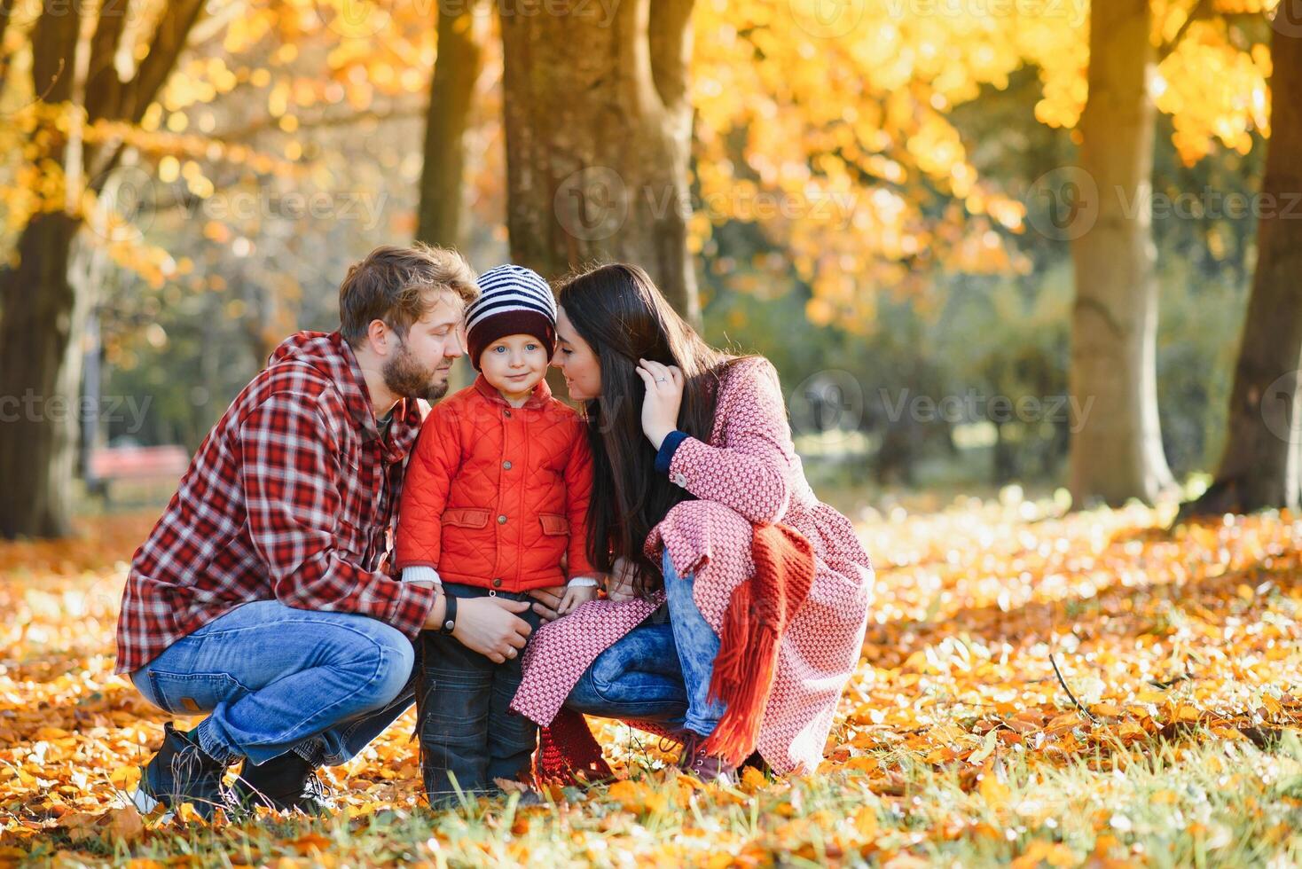 Young family walking in the park. Autumn. photo