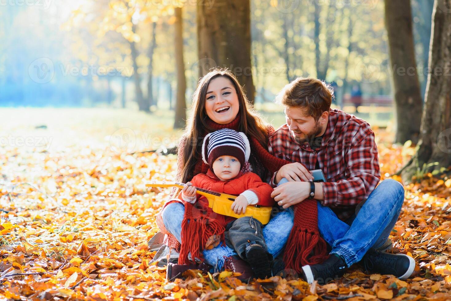 happy family mother father and baby on autumn walk in the park photo