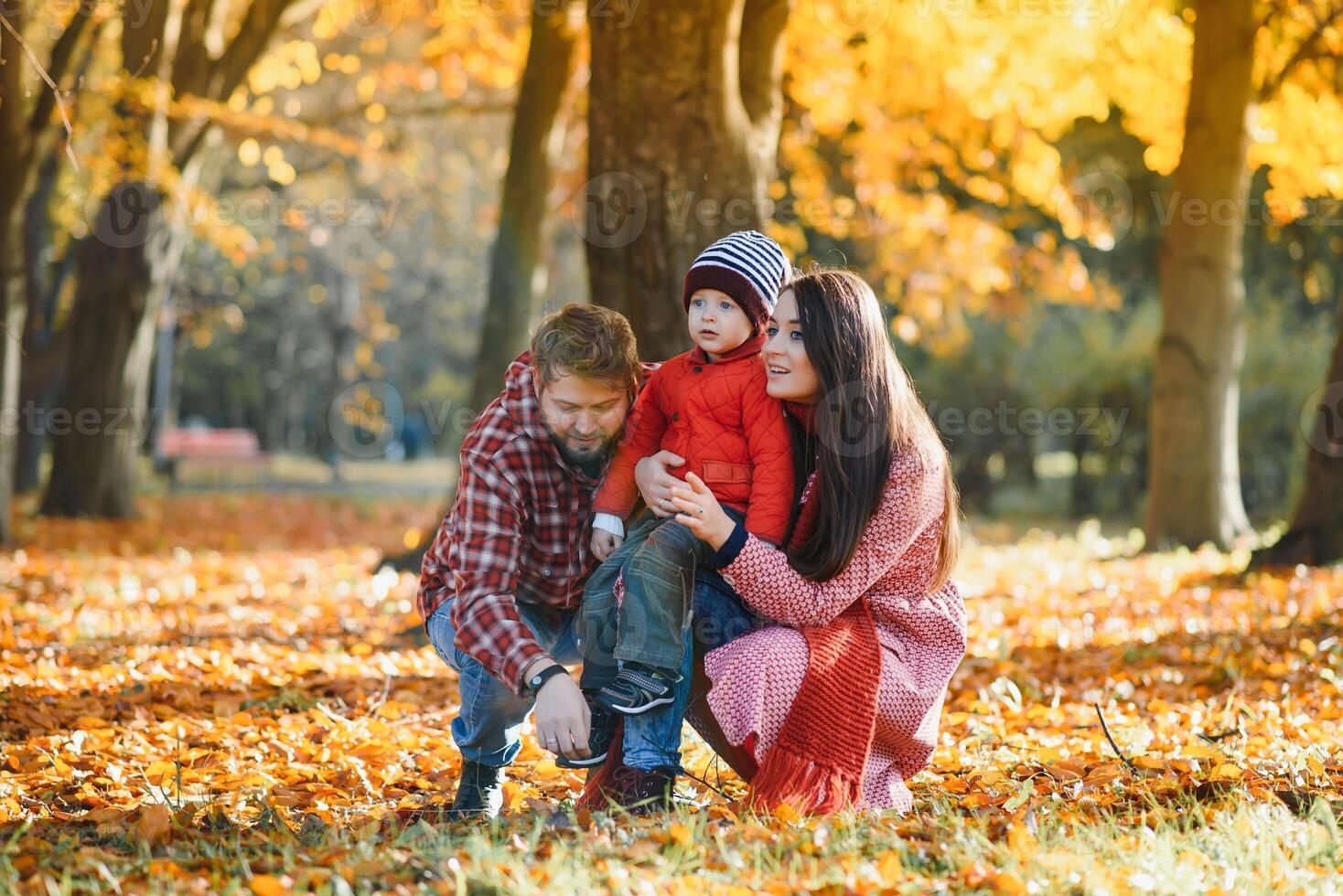 happy family mother father and baby on autumn walk in the park photo