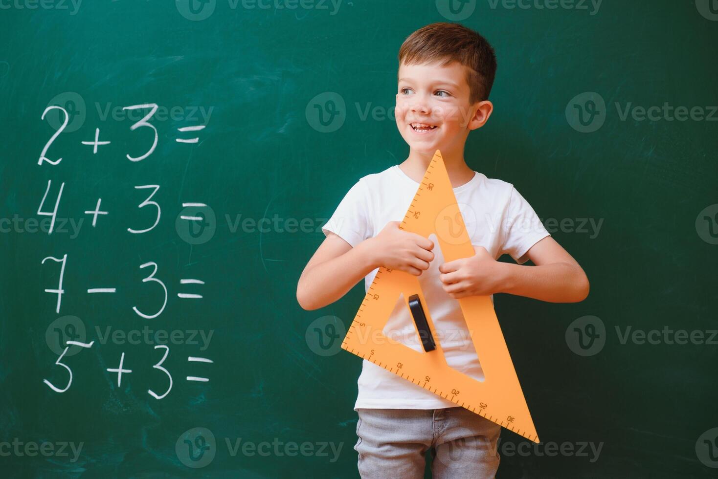 Back to school concept. School child in class. Happy kid against green blackboard. Smart child in classroom. Idea and education concept photo