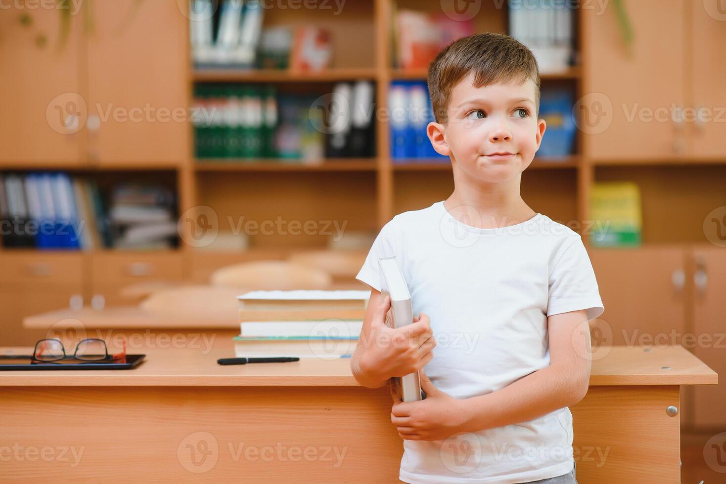 Boy in the school classroom. Back to school. photo