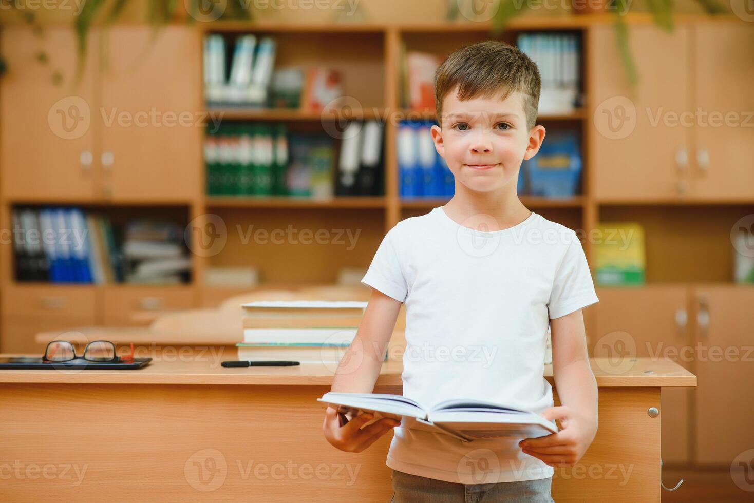 Boy in the school classroom. Back to school. photo